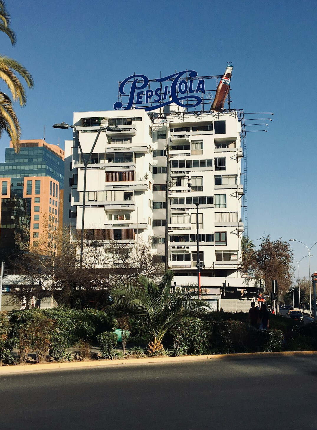 Tree-lined street with modern buildings and outdoor cafes in Providencia, Santiago